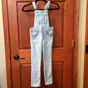 Girls light denim overalls.